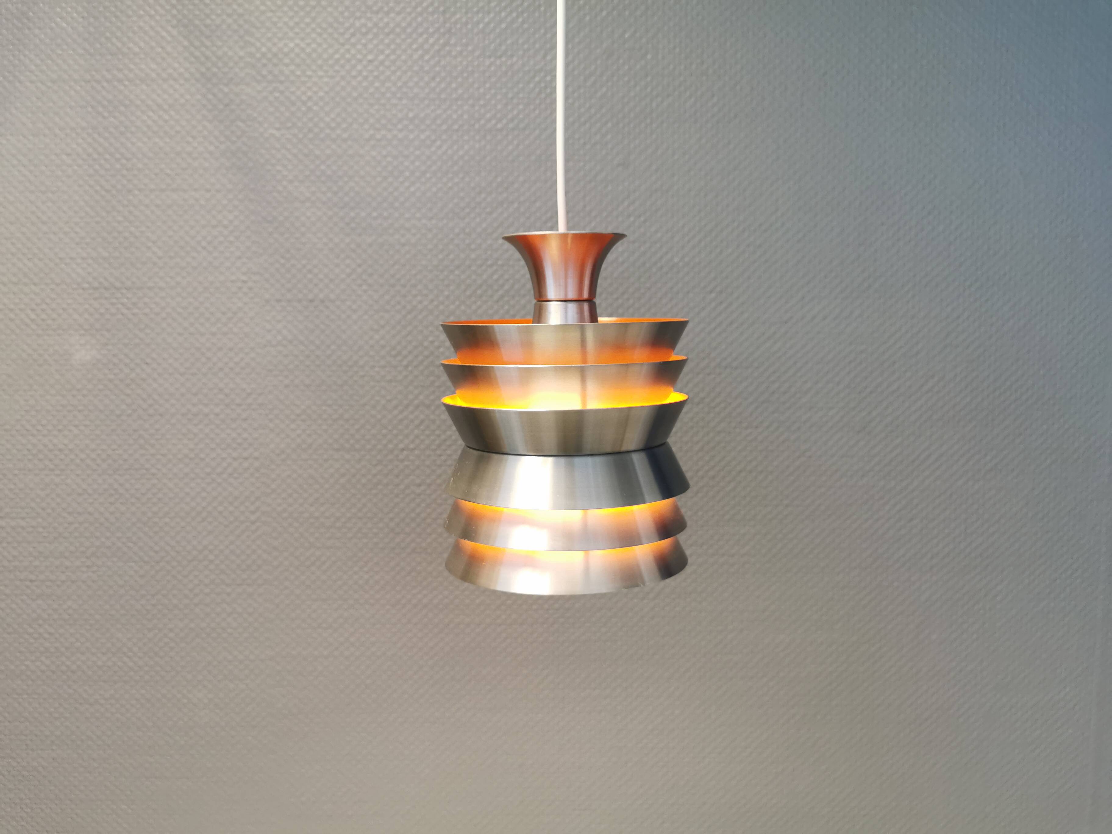 Danish/Swedish hanging lamp, in silver-coloured aluminium with orange interior paint.