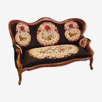 Two-seater sofa from the 1950s with wooden structure and covered with an embroidered fabric