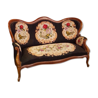 Two-seater sofa from the 1950s with wooden structure and covered with an embroidered fabric