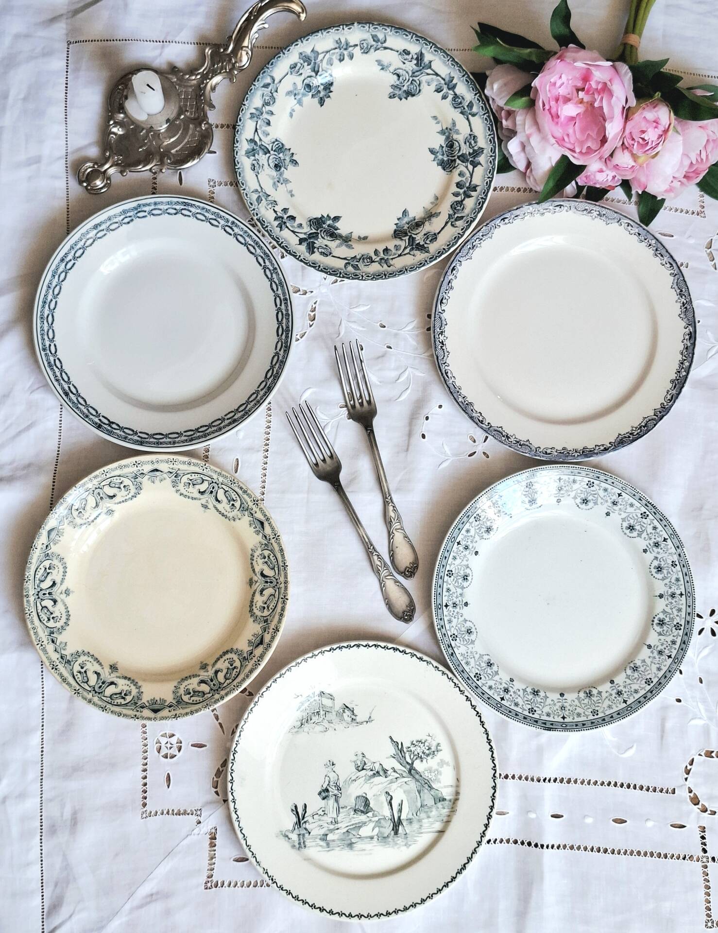 Old mismatched flat plates made of ironstone earthenware.
