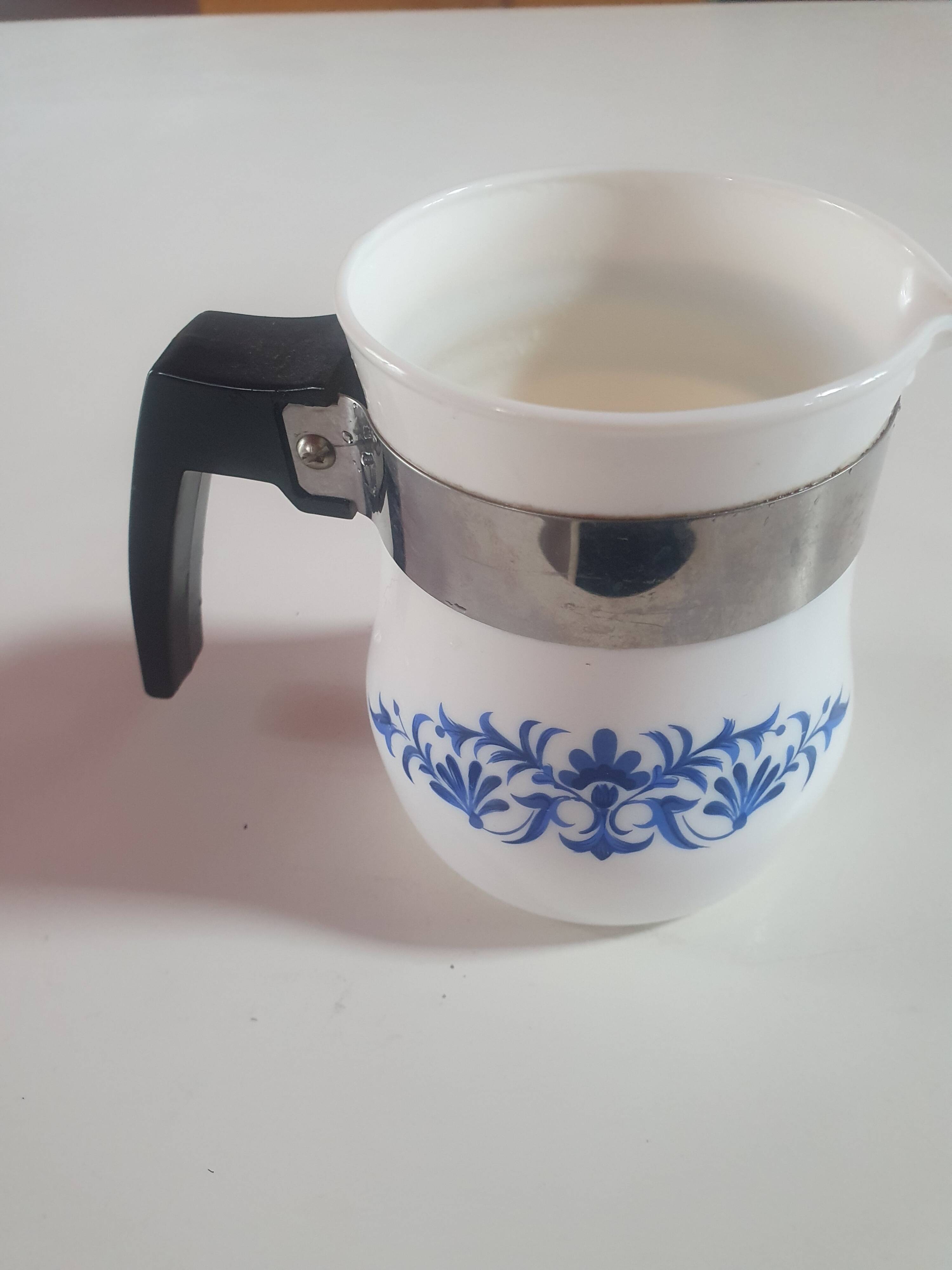 white ceramic milk jug with blue flowers, metal handle