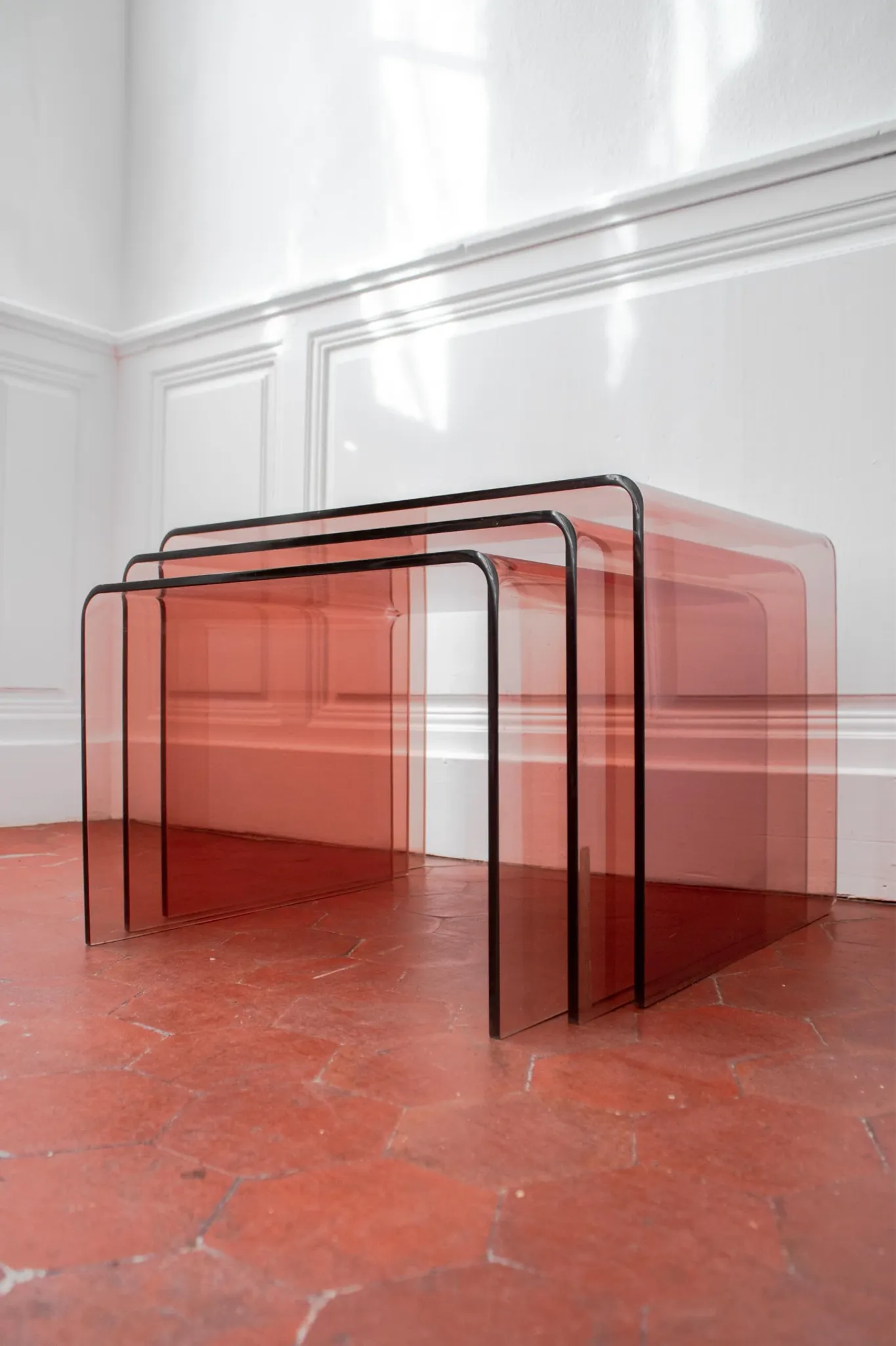 Vintage trio of nesting tables in smoked plexiglass by Michel Dumas, year
