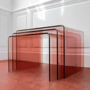 Vintage trio of nesting tables in smoked plexiglass by Michel Dumas, year
