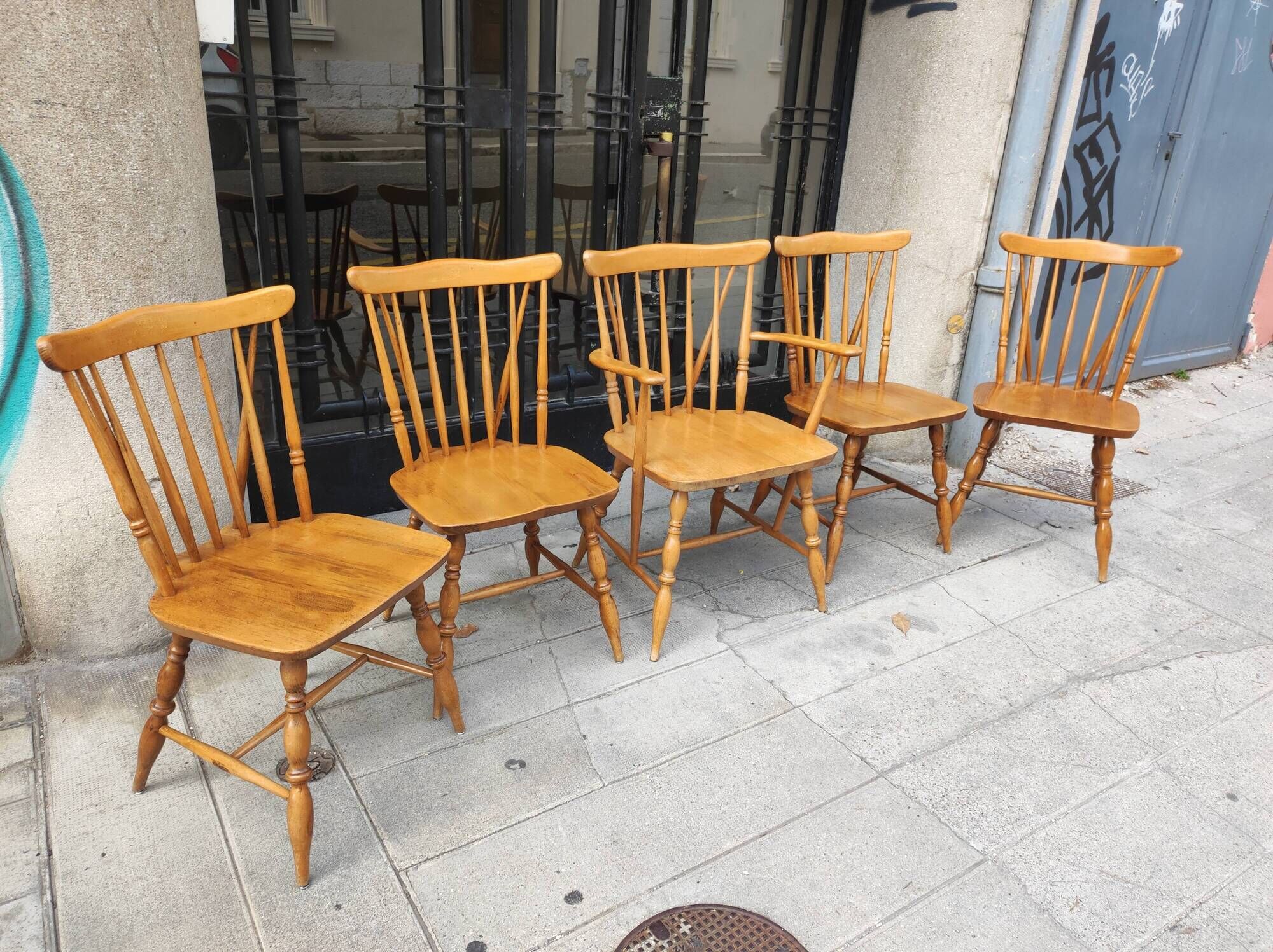 Four chairs and a Heywood Wakefield Windsor armchair. Vintage