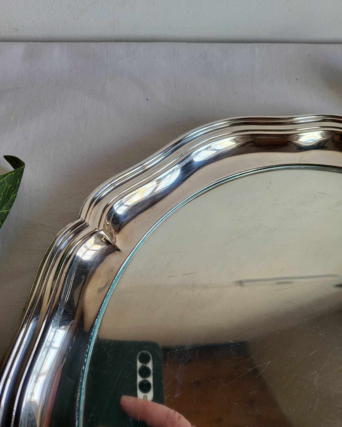 Round silver-plated serving dish with a glass base.