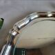 Round silver-plated serving dish with a glass base.