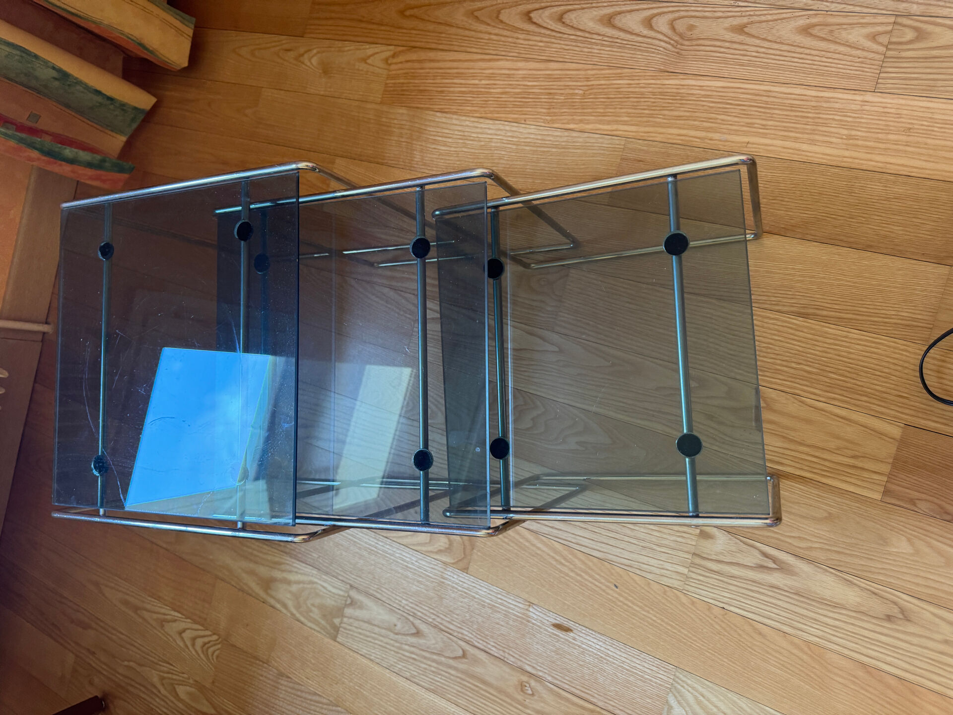 Nest of coffee tables in glass and metal.