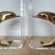 Dolphin bookends in gold metal and plexiglass – 1980s