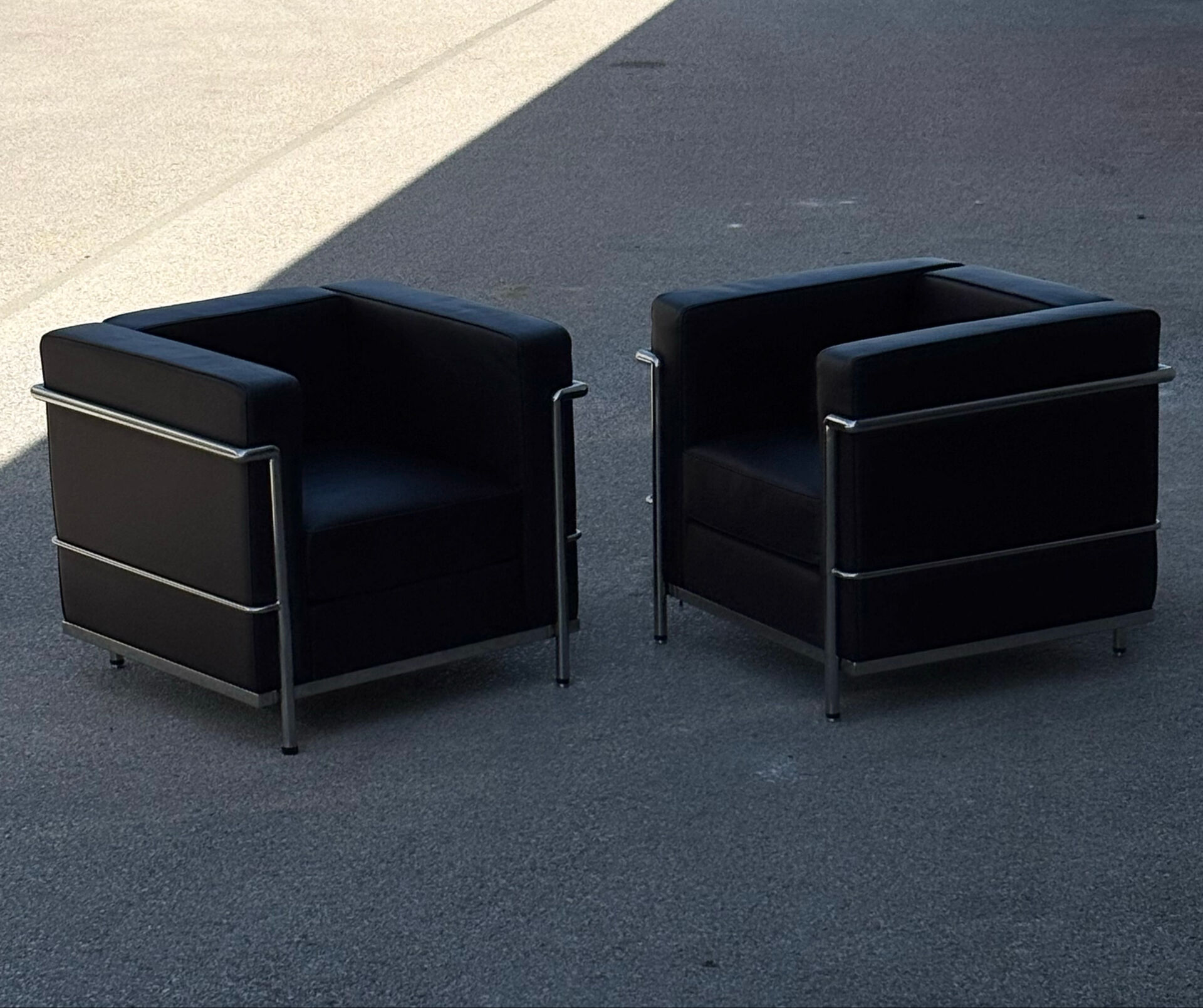 Pair of modernist brown leather armchairs