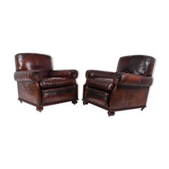 Antique leather club armchairs by Maple and Co 1910