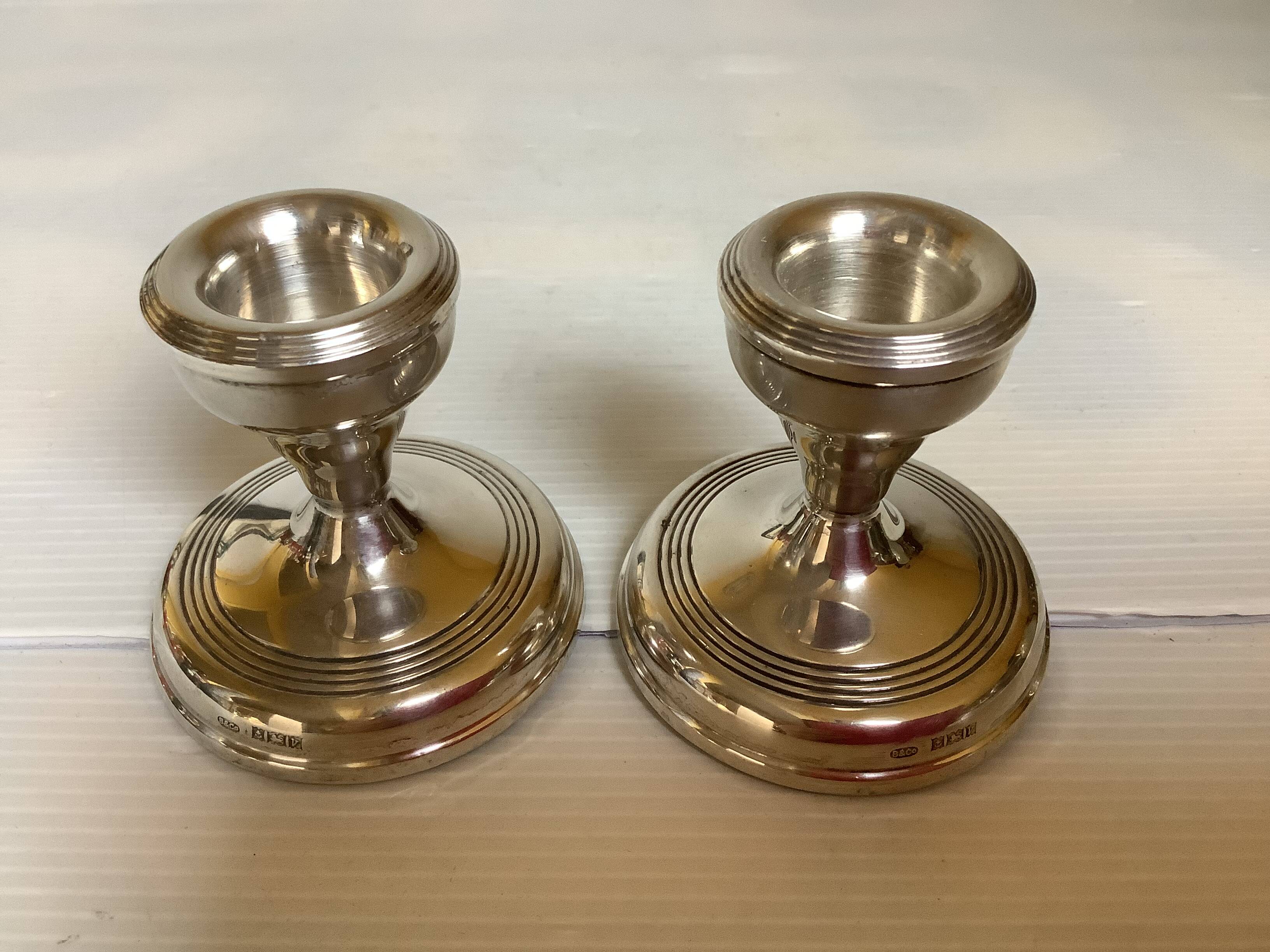 Pair of small silver candlesticks with hallmarks