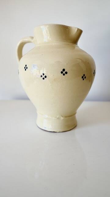 Vintage butter yellow ceramic pitcher in rustic style