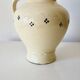 Vintage butter yellow ceramic pitcher in rustic style