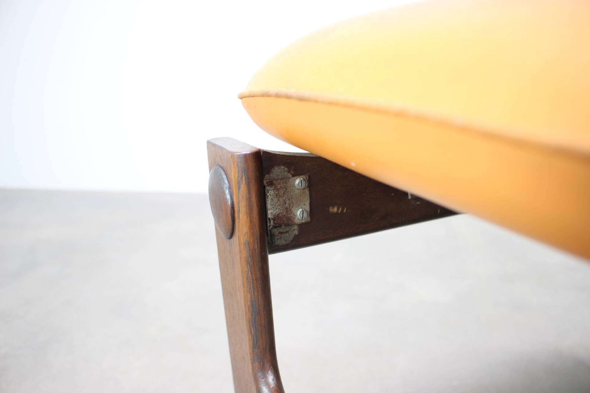 Vintage German sculptural chair from the 1970s in wood with orange faux leather.