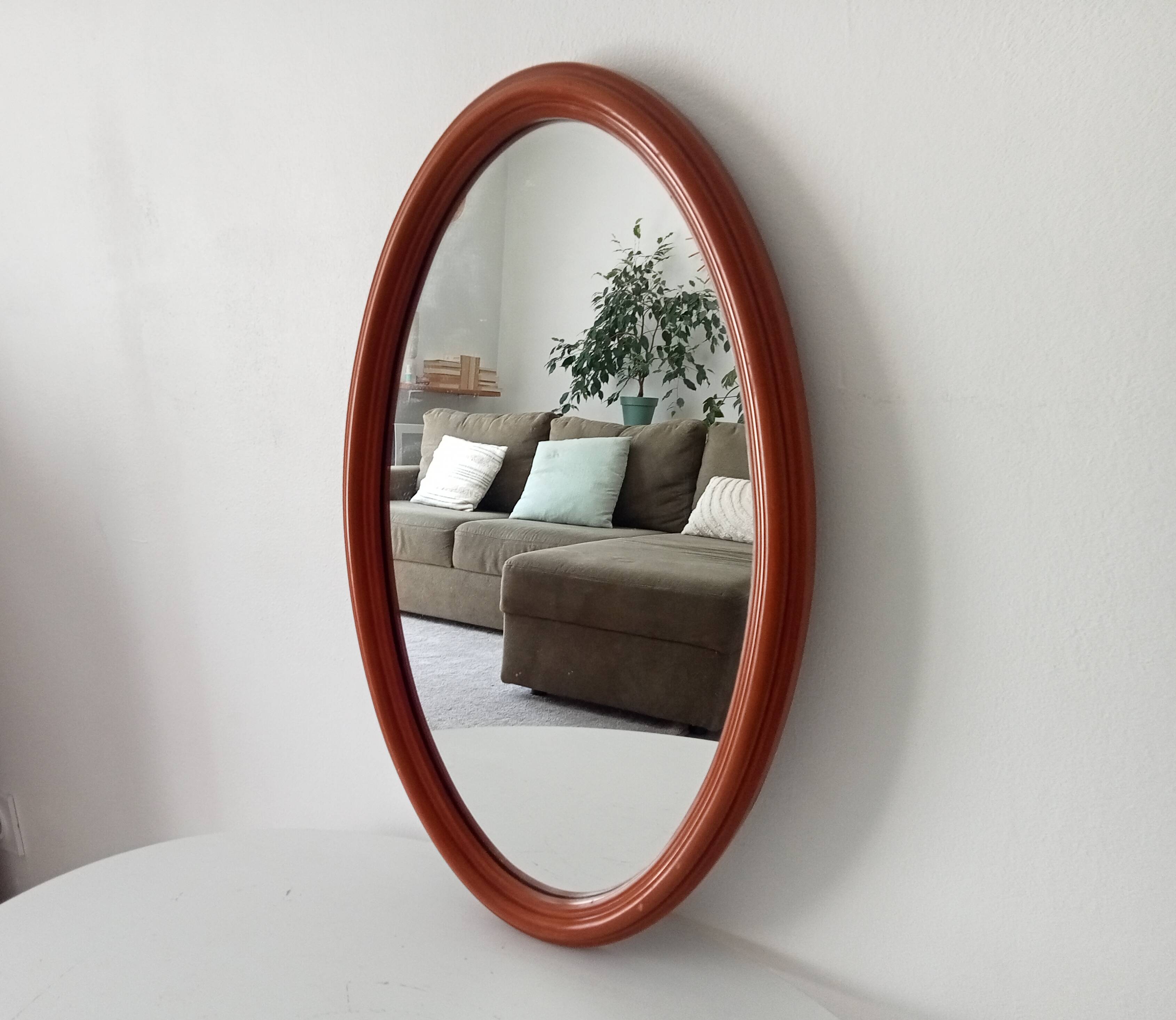 Vintage oval wooden mirror "caramel" from the 1960s.