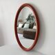 Vintage oval wooden mirror "caramel" from the 1960s.
