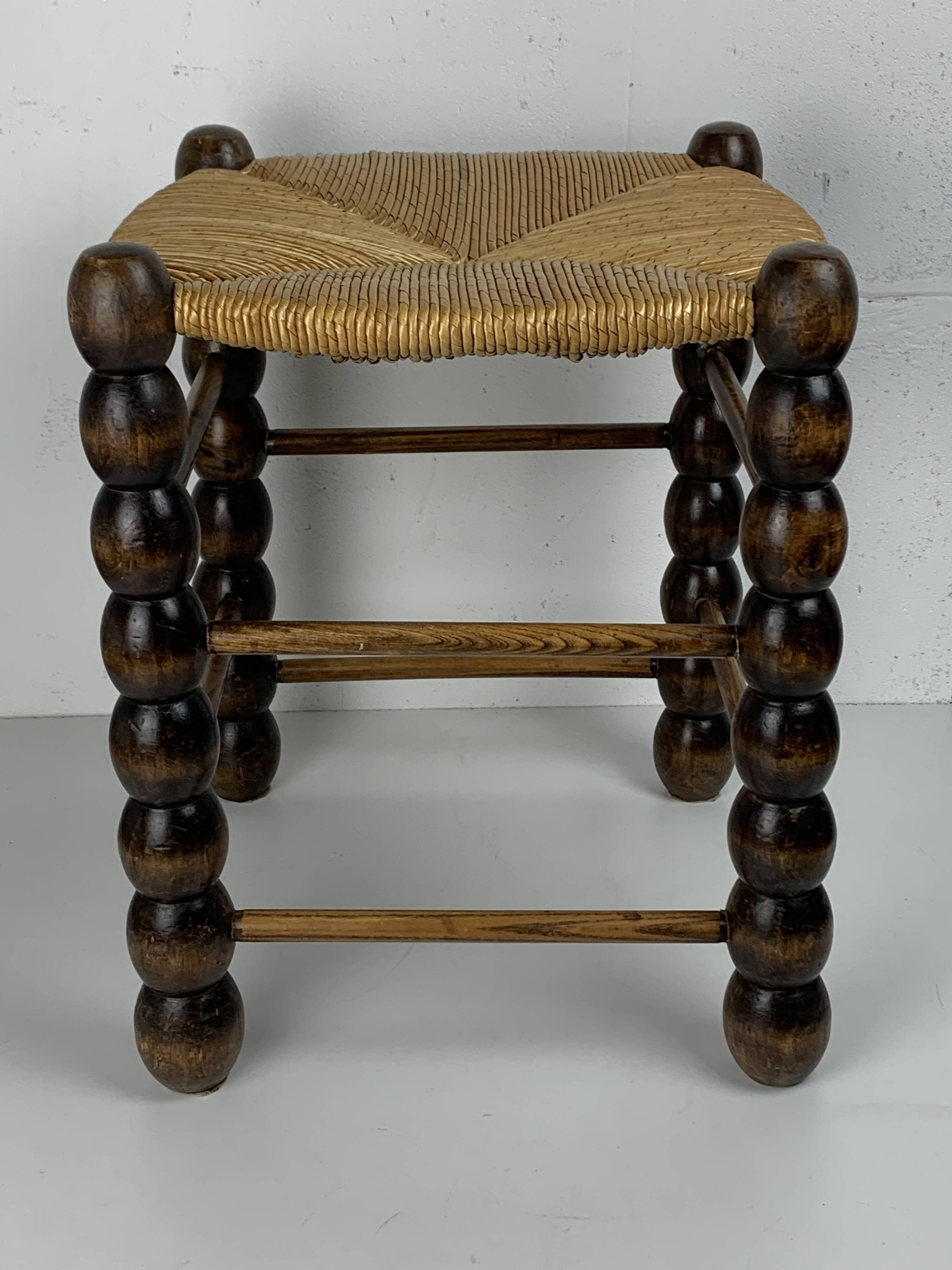 Brutalist wood turned bobbin rush stool in the style of Charles Dudouyt