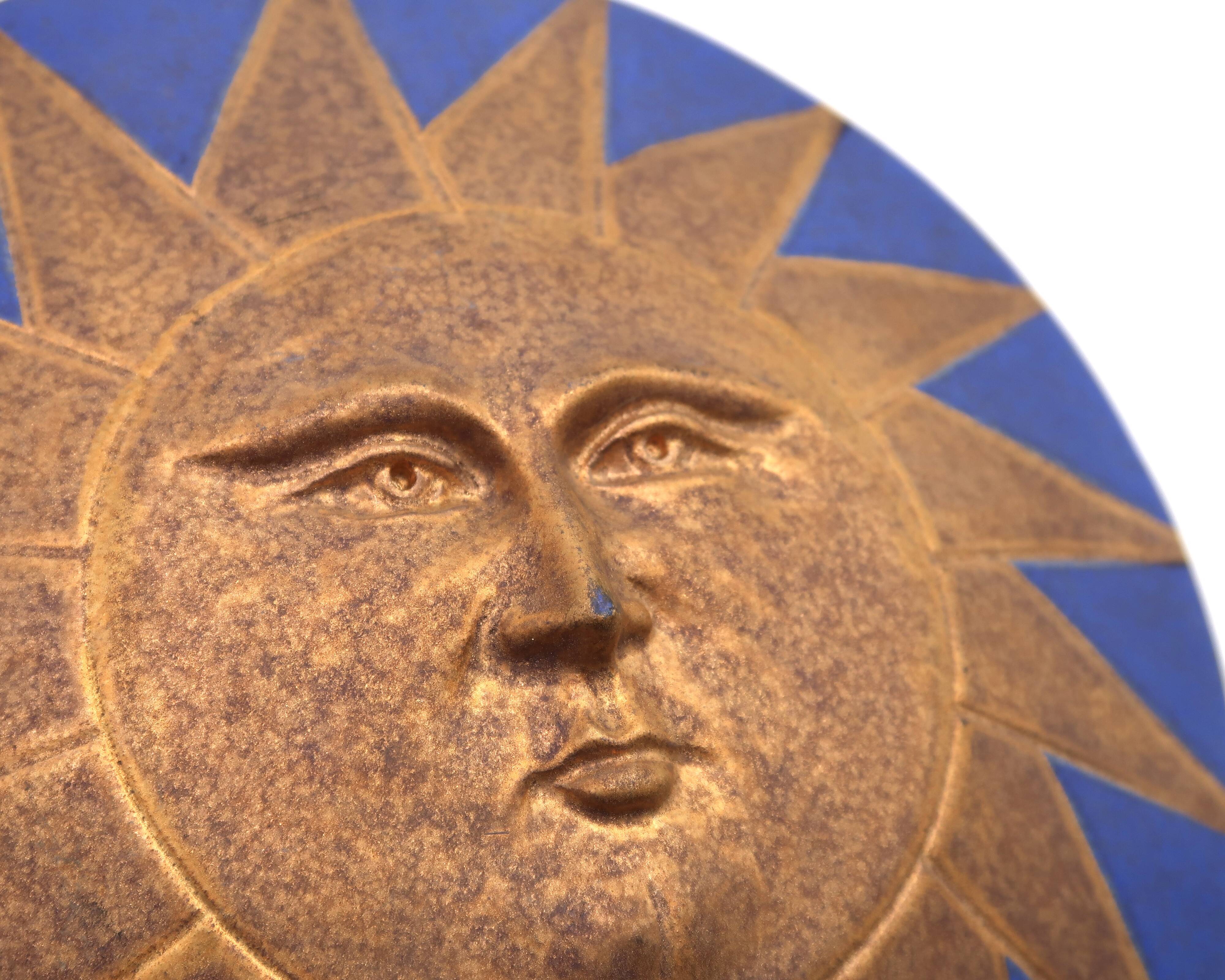 Relief mural signed in ceramic, sun with blue and gold face, 1990s.
