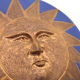 Relief mural signed in ceramic, sun with blue and gold face, 1990s.