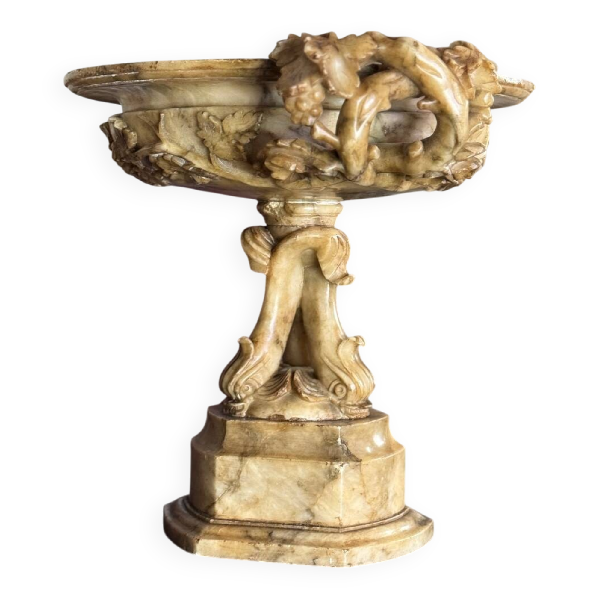 Alabaster bowl decorated with vine leaves on a base of three dolphins, circa 1880.
