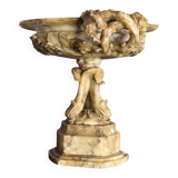 Alabaster bowl decorated with vine leaves on a base of three dolphins, circa 1880.