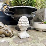 Ornamental pine cone in bleached concrete