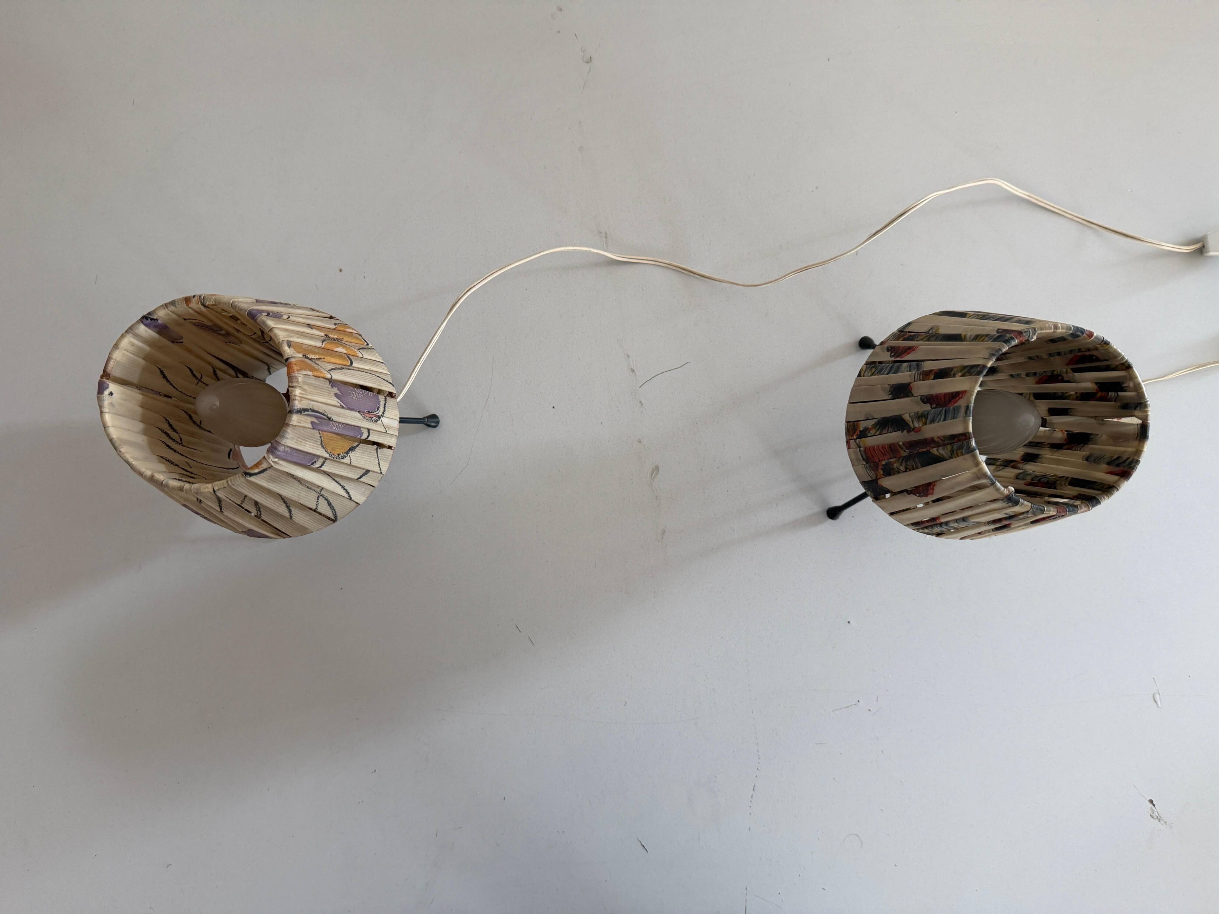 Pair of table lamps with plastic shades and tripod base, 1960s, Italy
