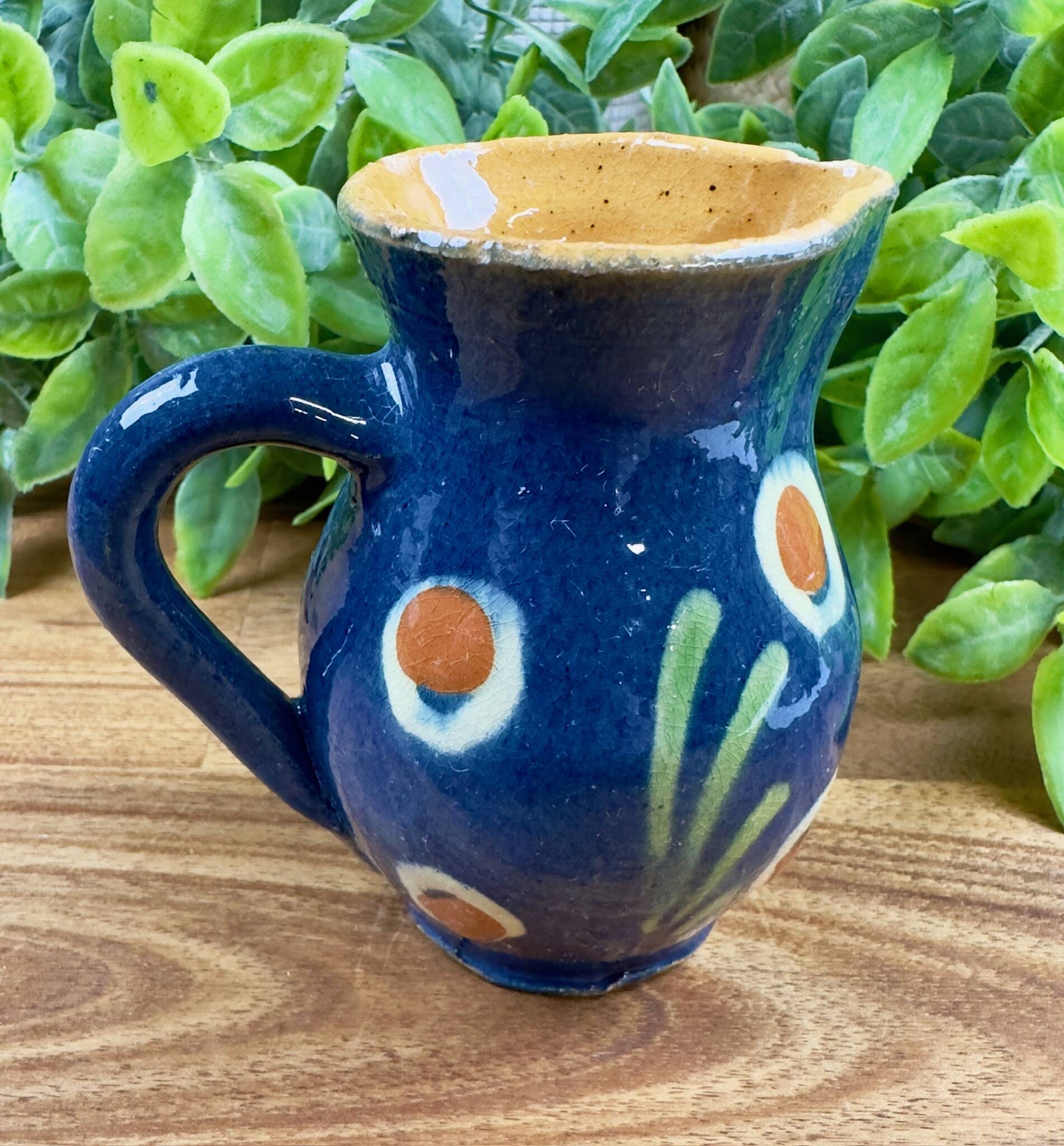 Small blue ceramic jug with hand-painted floral decoration, vintage.