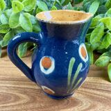 Small blue ceramic jug with hand-painted floral decoration, vintage.
