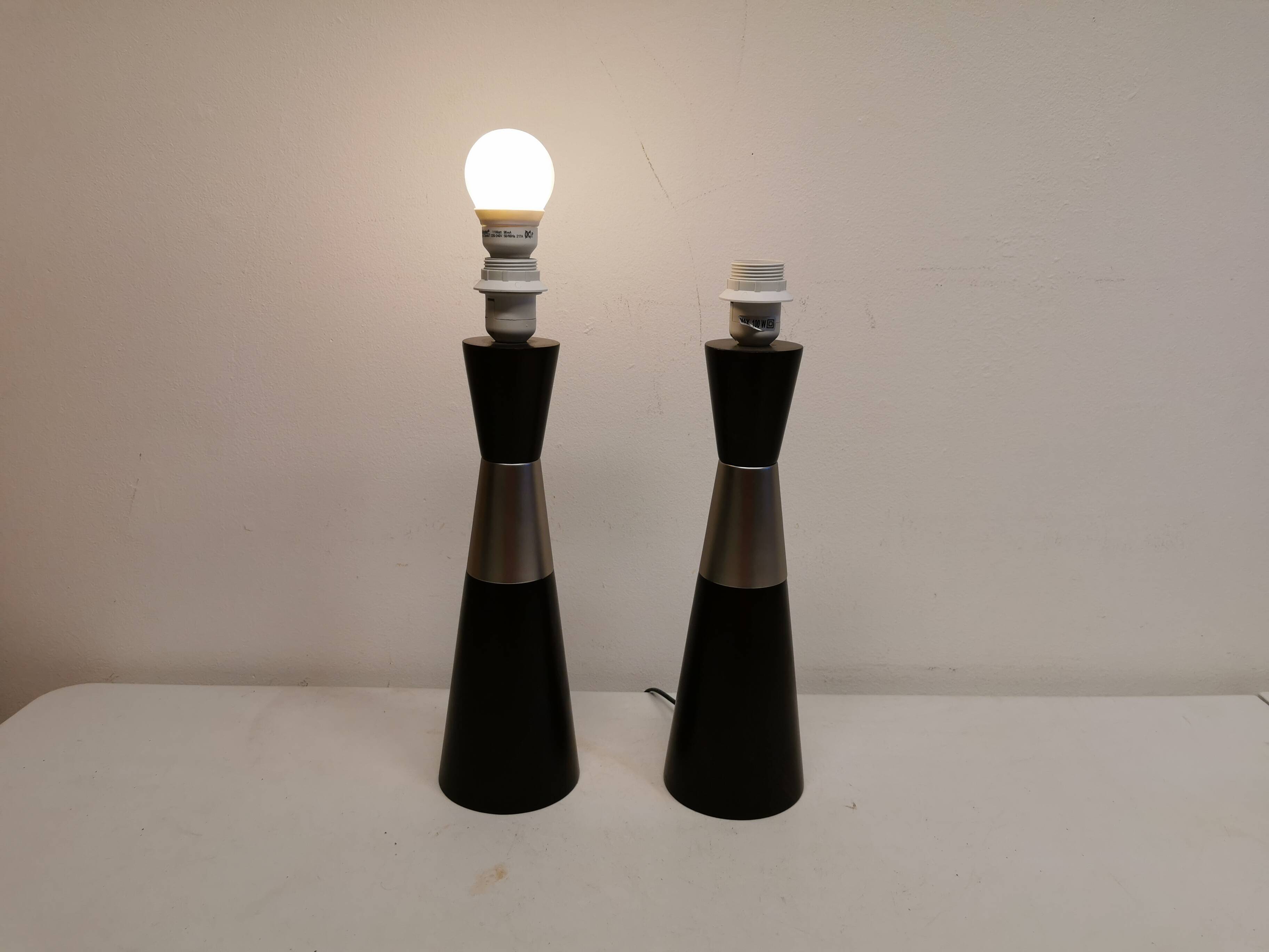 Two table lamps made of dark-stained wood with silver detail in the middle.