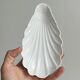 Set of white porcelain ramekins, ribbed shell shape.