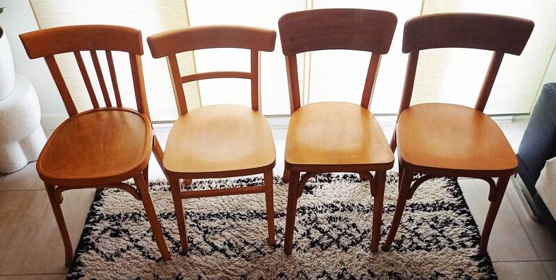 Set of 4 light wood bistro chairs stamped Baumann and Thonet.