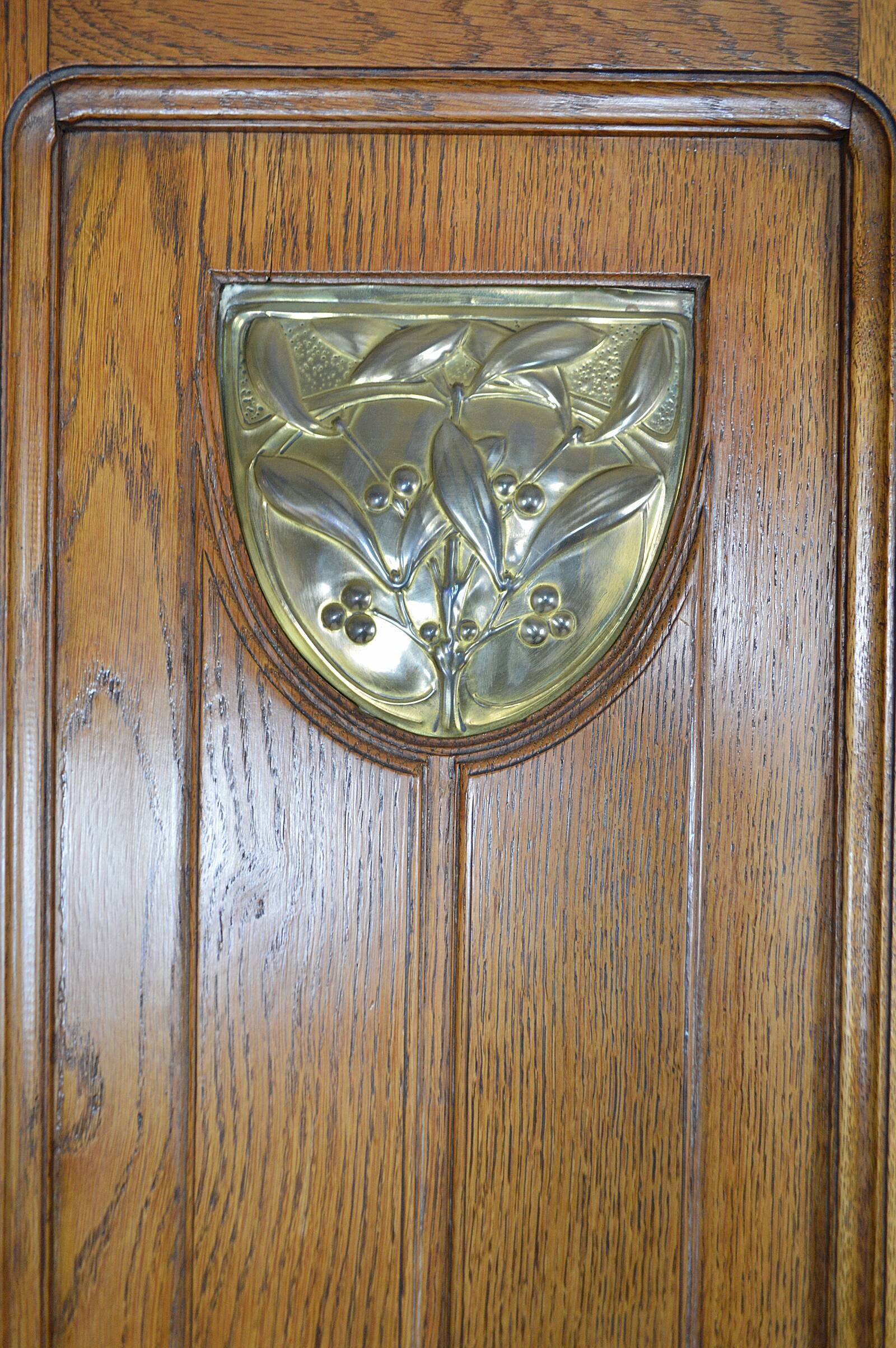 Art Nouveau oak buffet and dinanderie panels, circa 1910