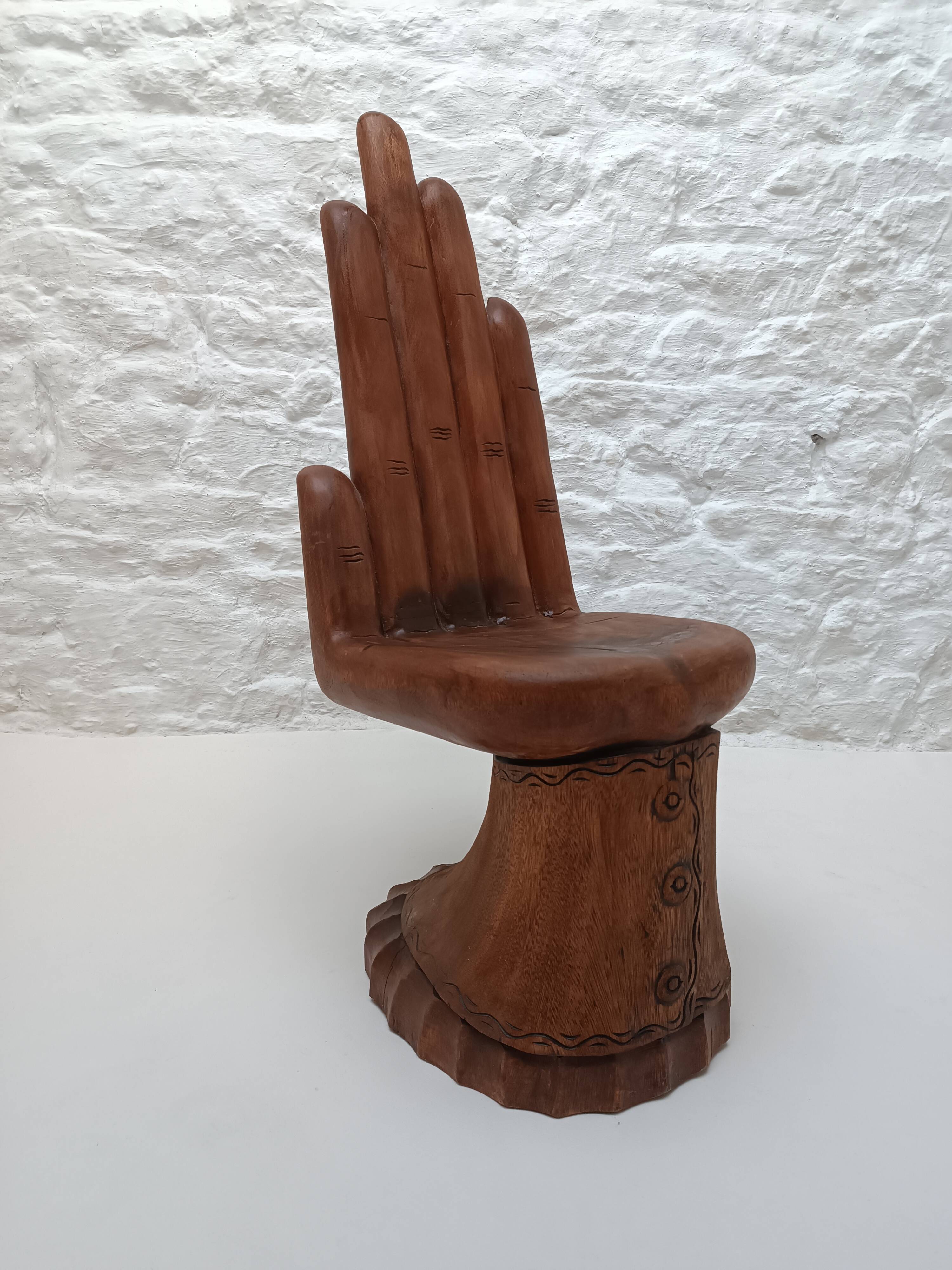 Sculpted wooden chair in the shape of a hand, 1960.