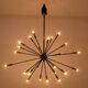 Sputnik-shaped chandelier in patinated gold-plated brass and black lacquer. Contemporary.