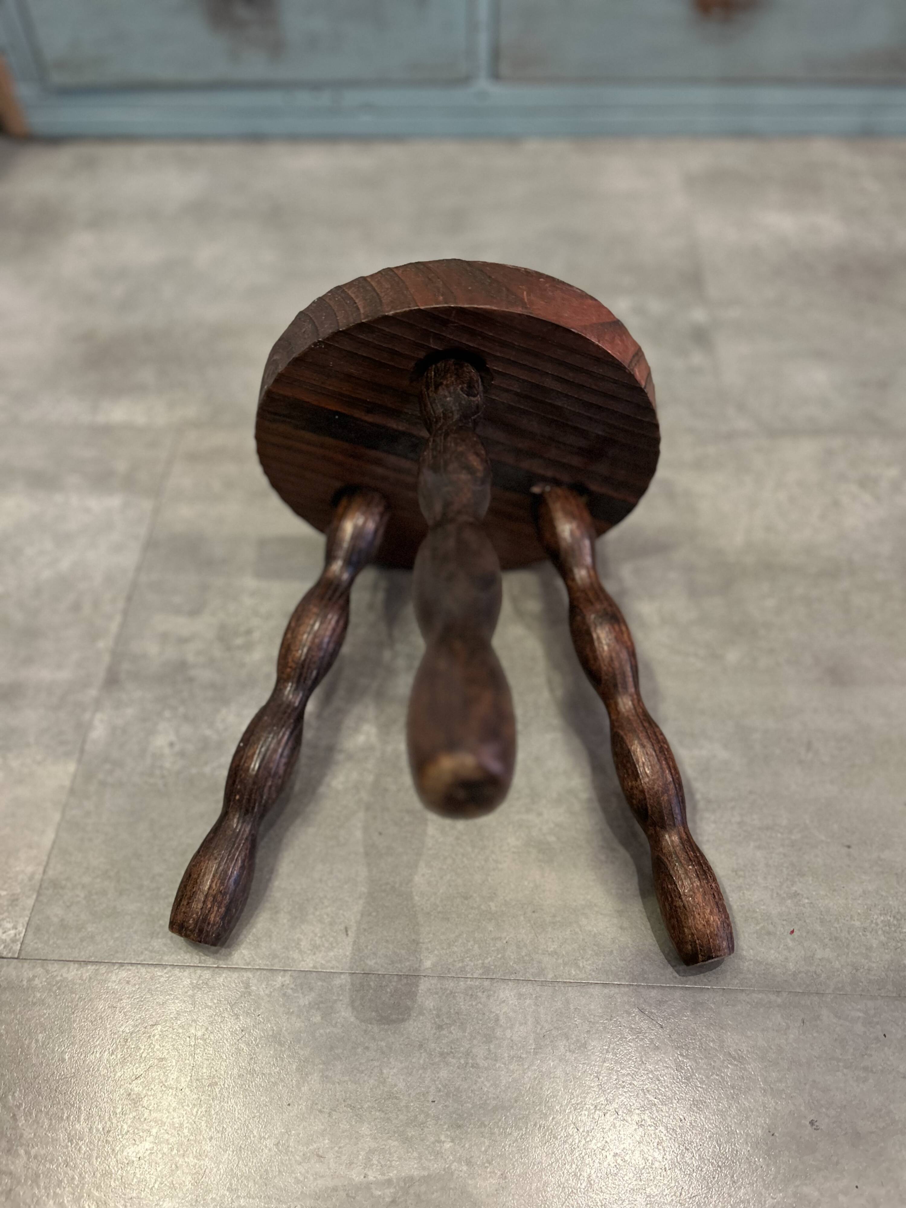 Three-legged stool with beaded wooden legs