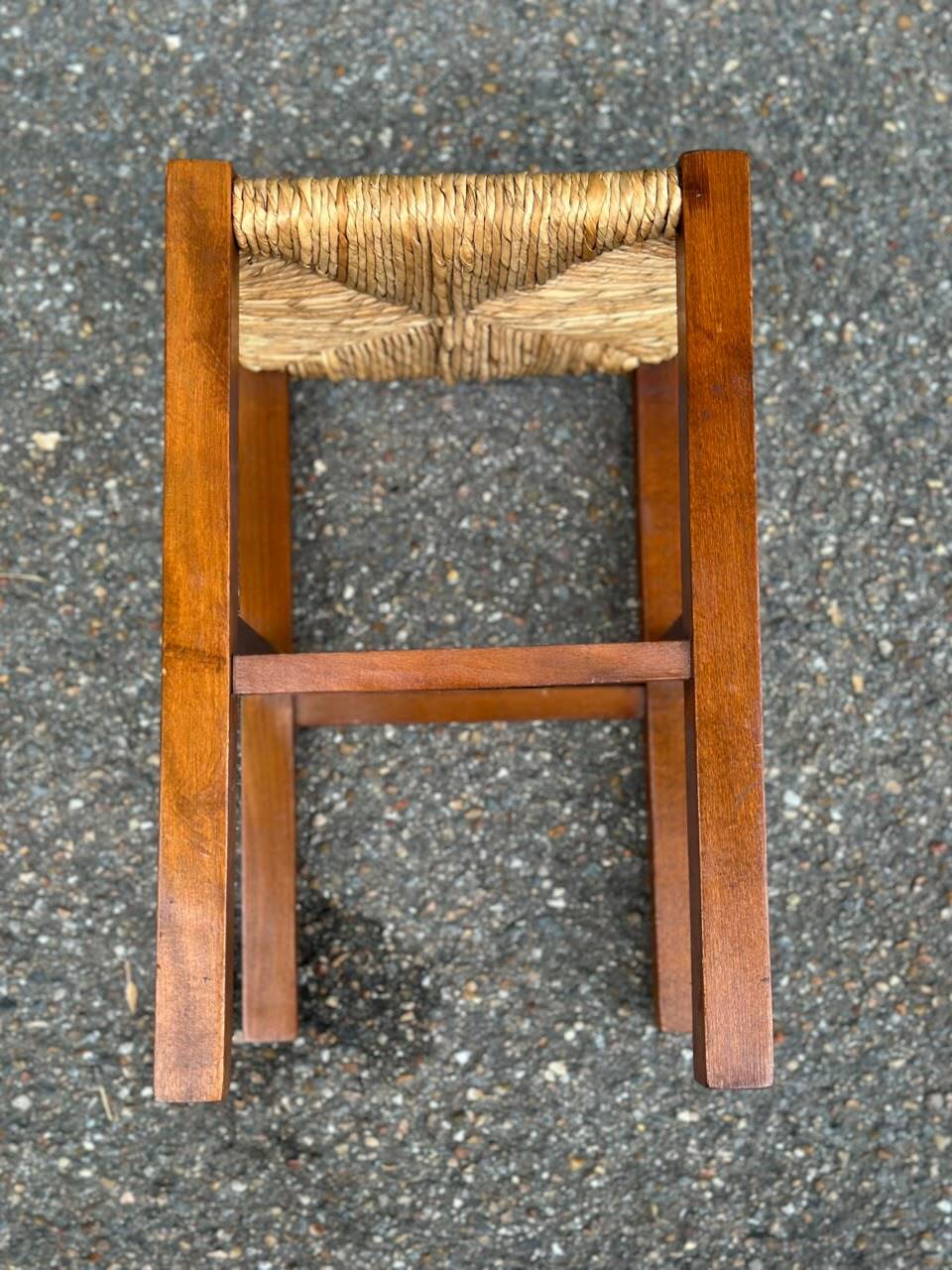 Low stool in brutalist style made of solid wood with straw, 1980.