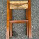 Low stool in brutalist style made of solid wood with straw, 1980.