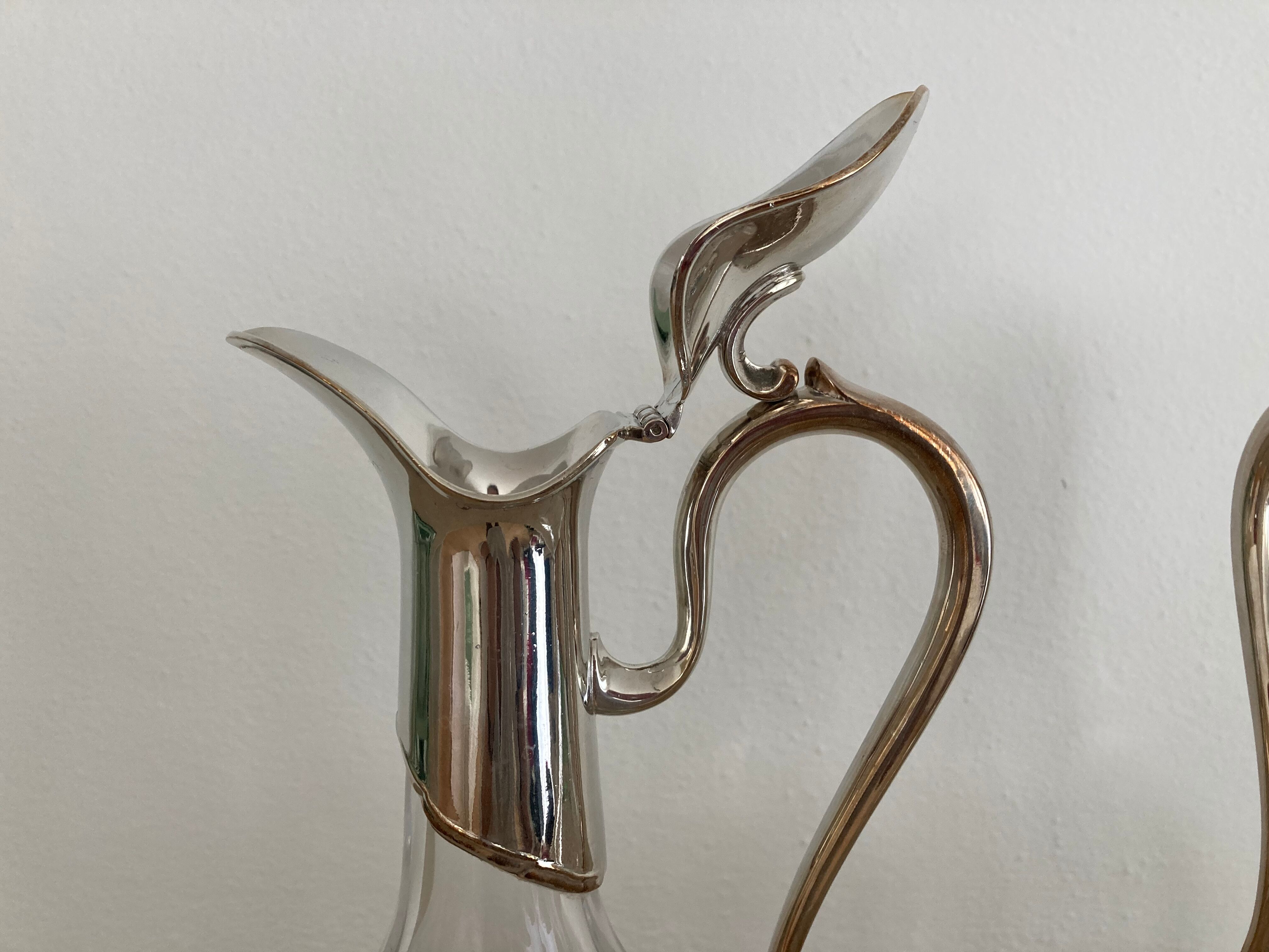 Glass decanters and silver metal spouts