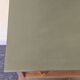 Renovated vintage bedside table in wood, with tapered legs – Matt green & gold background