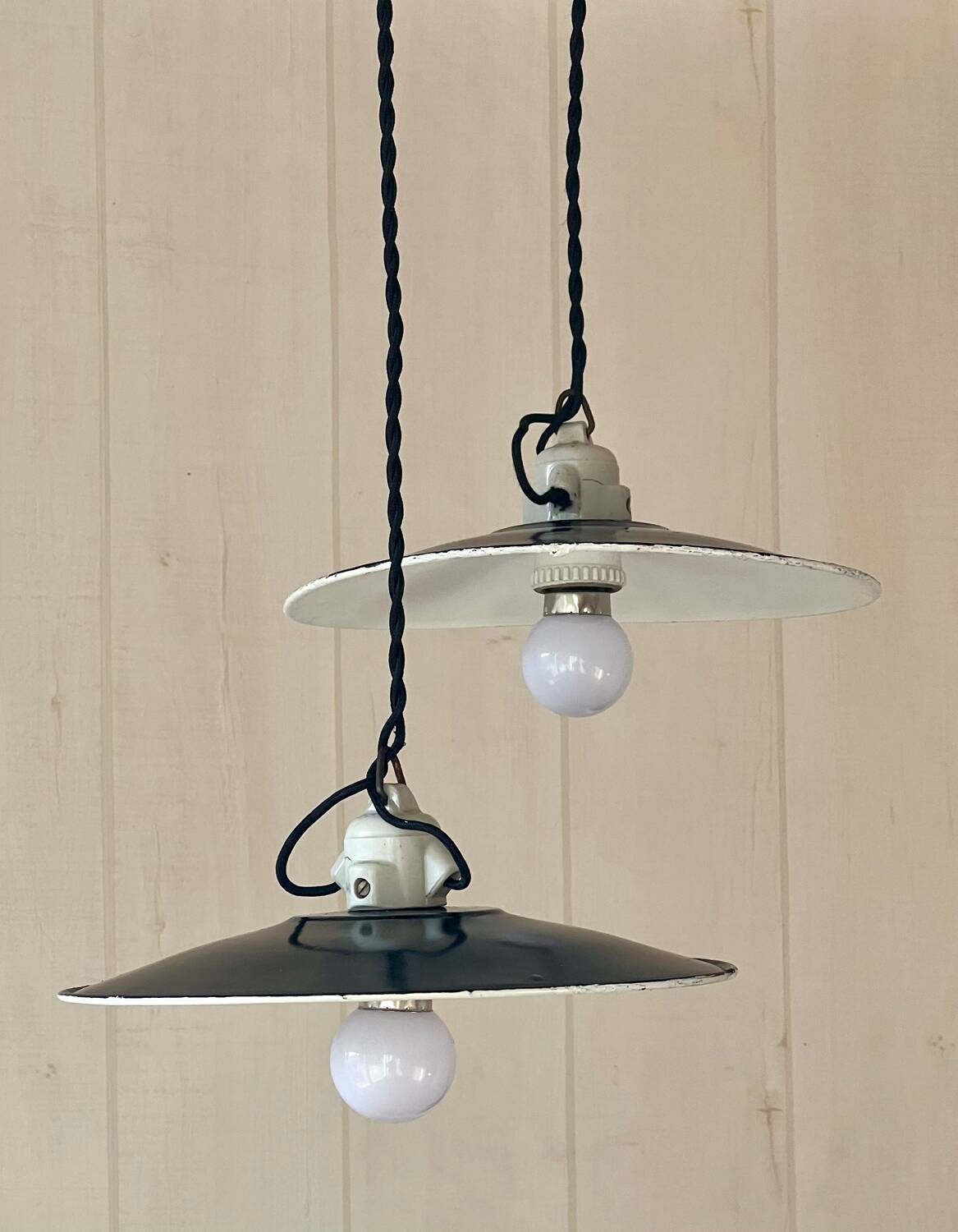 Pair of black and white sheet metal pendant lights, ceramic sockets