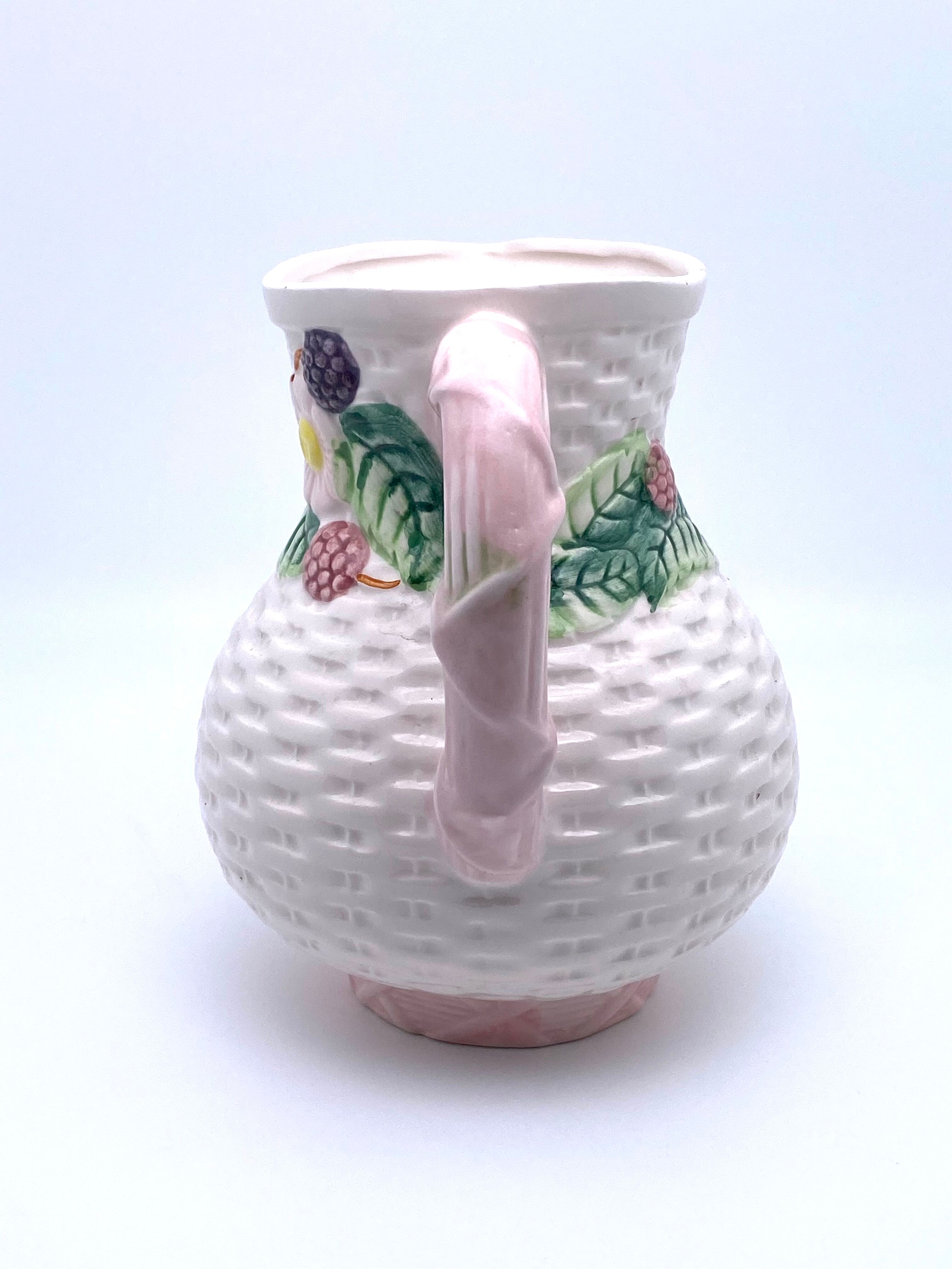 Pale pink slip decanter and colorful fruist