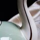 Antique Villeroy and Boch ceramic teapot in gold and celadon green.
