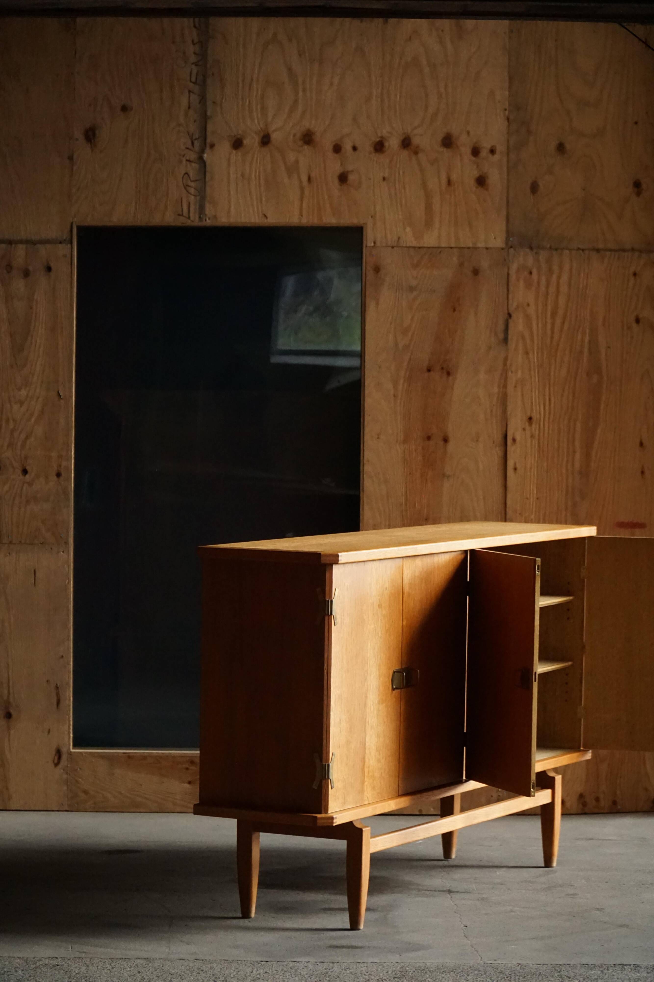 Oak and brass buffet by Henning Kjærnulf, Mid-century modern Danish, 1960s.