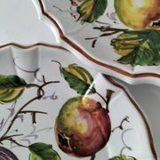 Set of three earthenware plates from Bassano, hand-painted with fruit and flower designs.