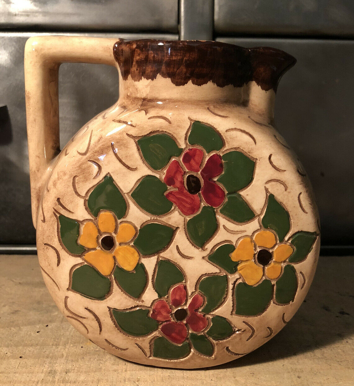 Ceramic pitcher with floral decoration signed Lucq