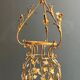 Important golden iron lantern with foliage decorations from the Baguès house.
