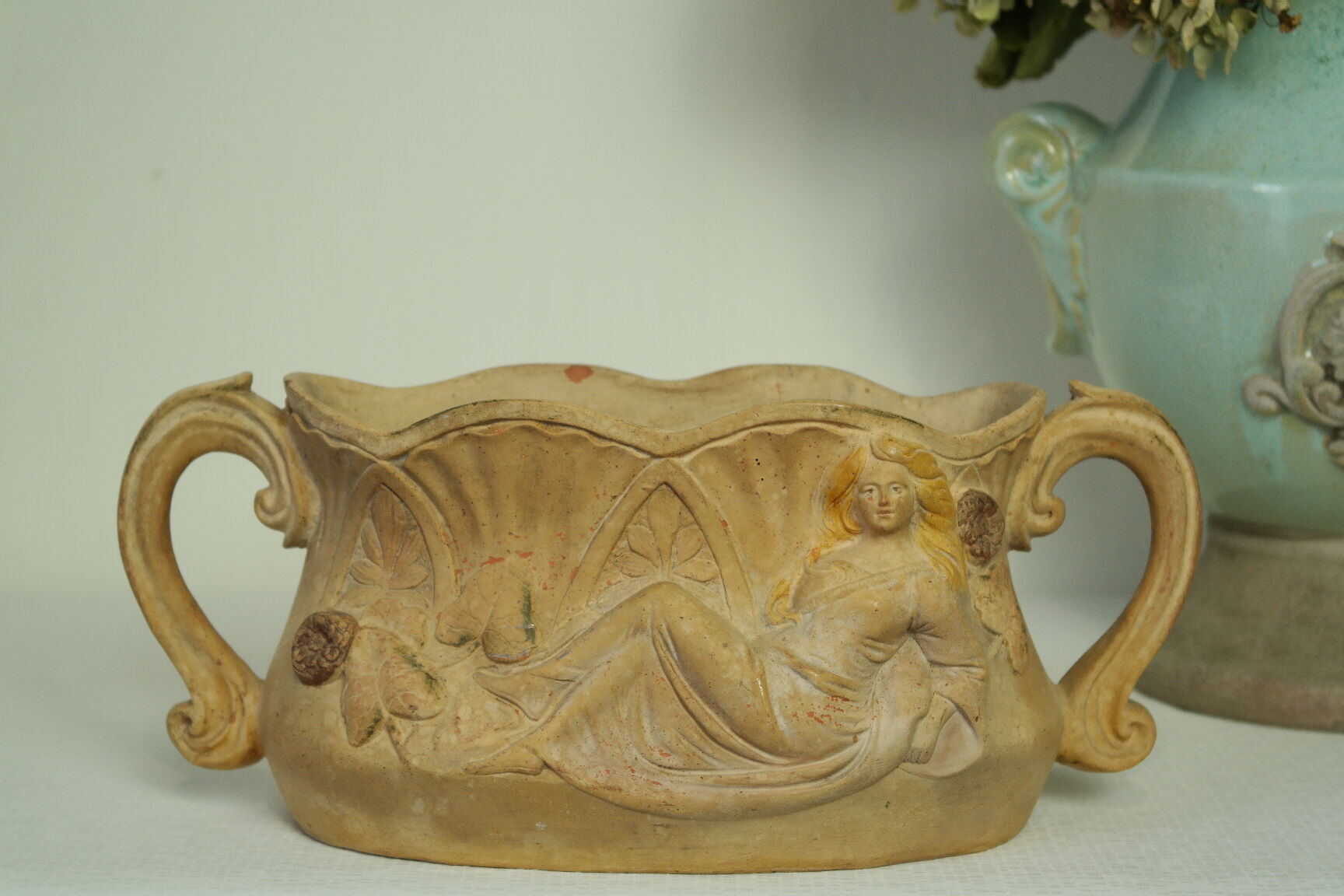 Art Nouveau jardinière with bas-reliefs in terracotta.