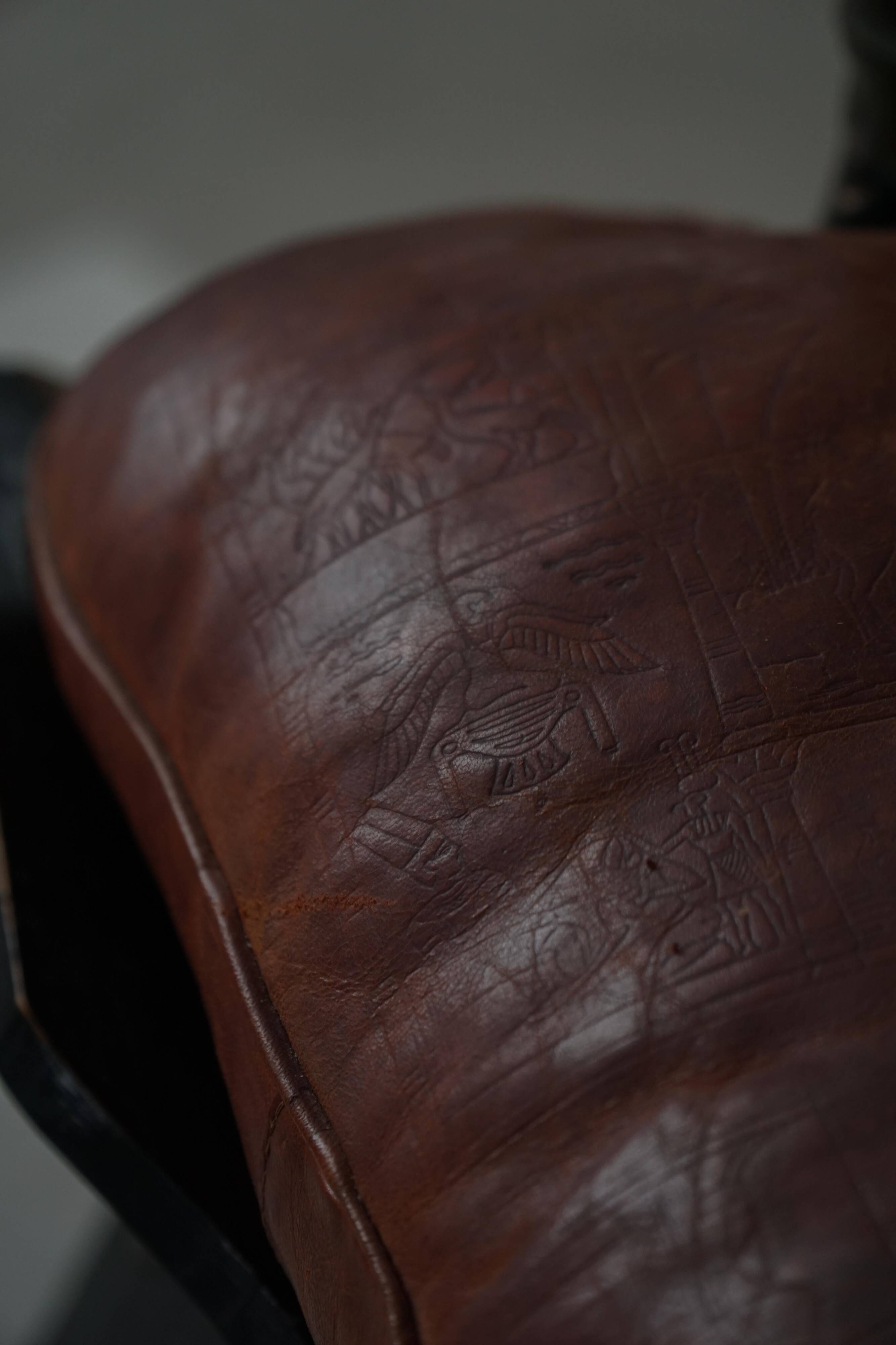Dark red upholstered camel saddle stool, 20th century, North Africa.