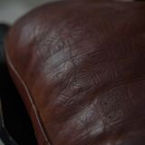 Dark red upholstered camel saddle stool, 20th century, North Africa.